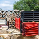 Construction site, building materials, old european city. Urban engineering, plastic and concret pipes, Europe