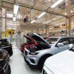 Modern car assembly plant. Auto industry. Interior of a high-tech factory, modern production of automobiles.