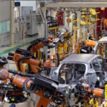 Photo of automobile production line. Modern car assembly plant. Modern and high-tech automotive industry.